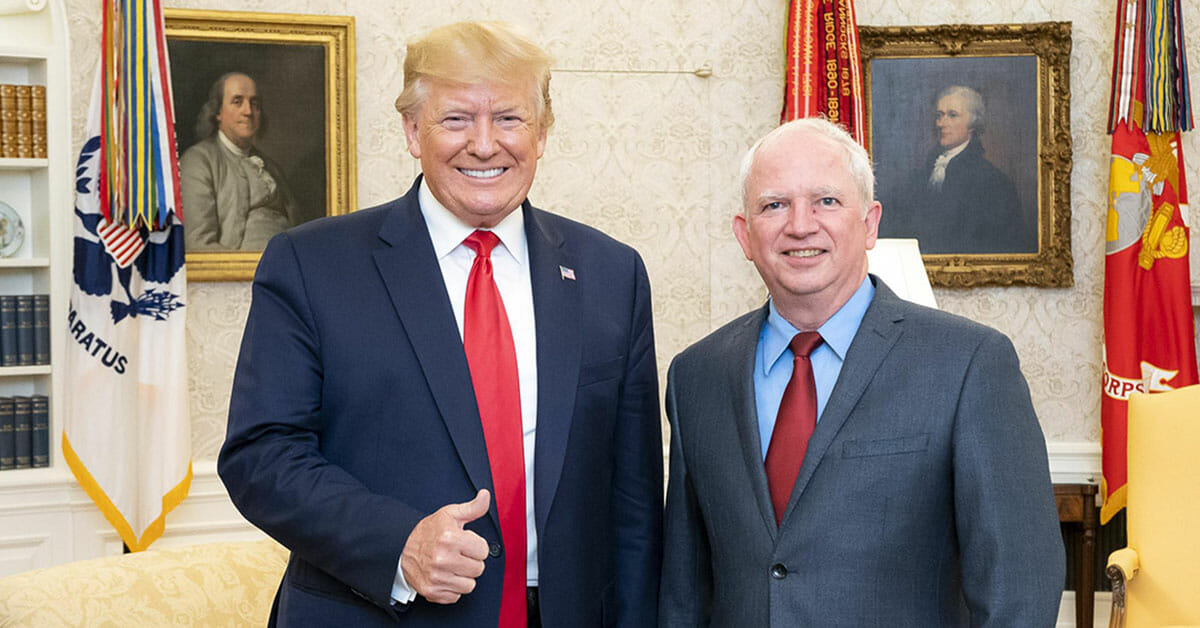 Attorney and embattled advisor to former president Trump John Eastman stands next to Trump in the White House. Eastman is seeking to overturn Colorado's open primary law.